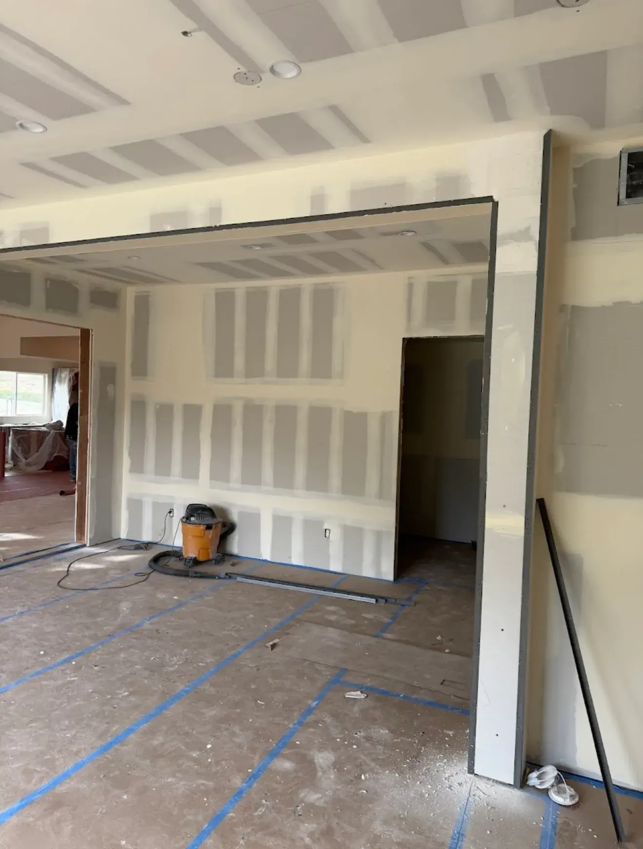 Finished drywall walls with a squared cased opening and metal corner bead set at the edges