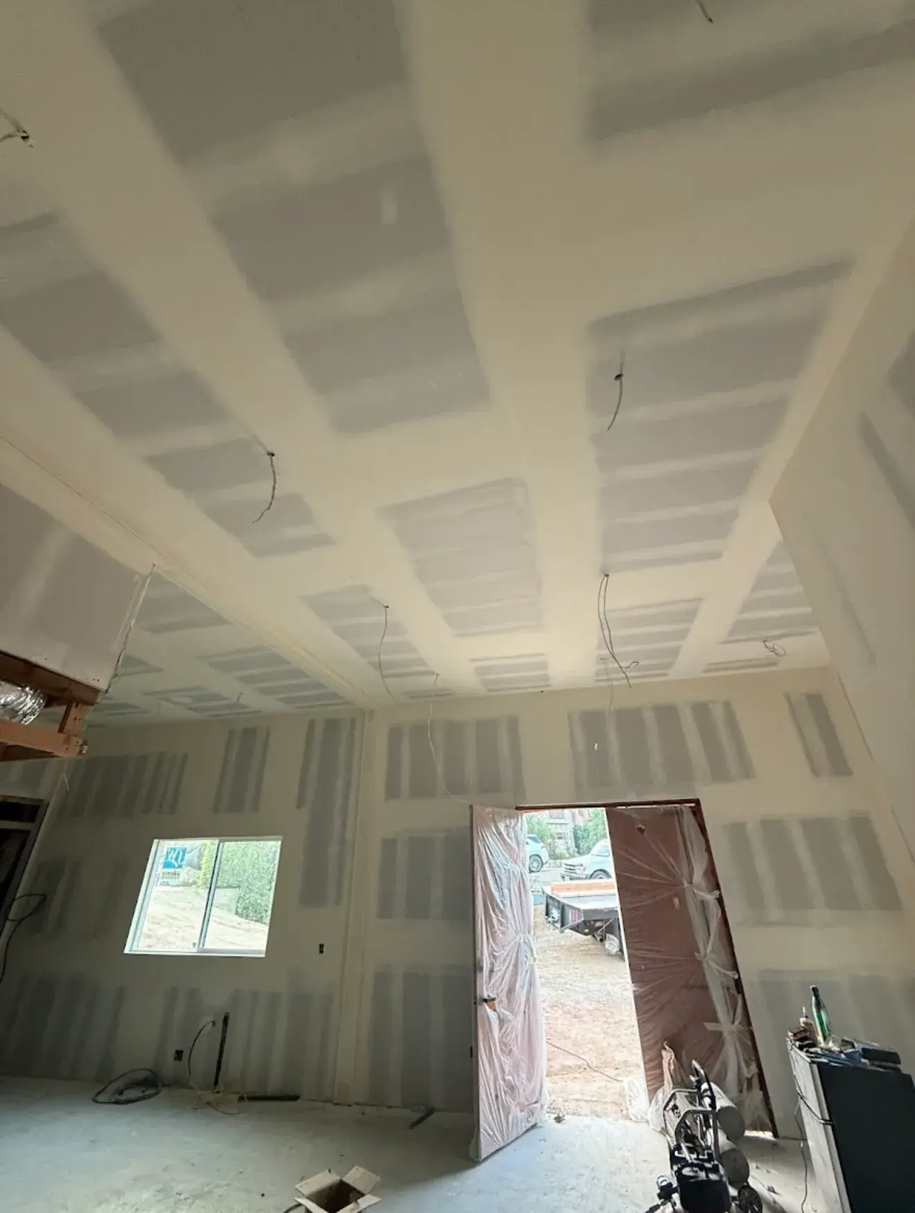 Recessed ceiling and walls taped and skim coated to a smooth level four drywall finish