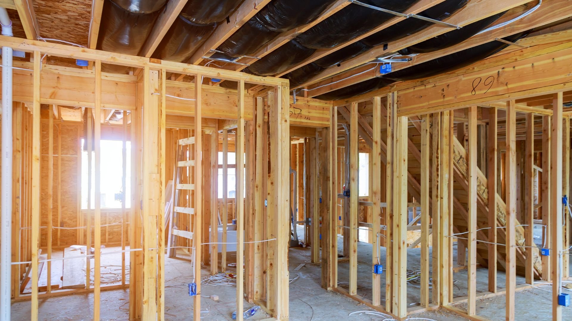 Interior wood framing of a house under construction with exposed studs
